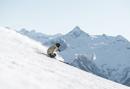 Skier on a snowy slope with Kitzsteinhorn in the background