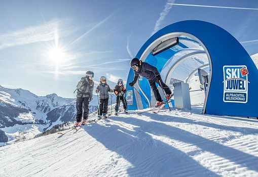 Family starting on the SkiMovie racetrack in the Alpbachtal Wildschönau ski area.