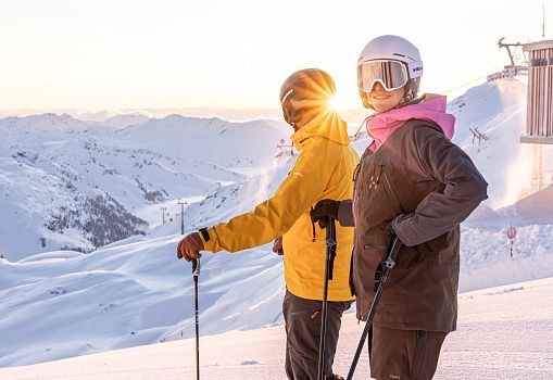 A couple with the sunrise in the background.